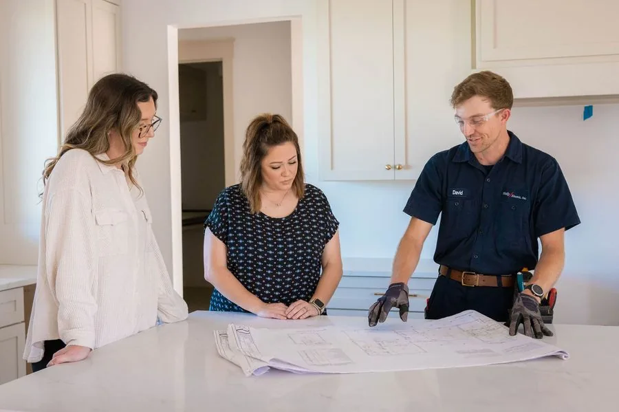The Holly Companies team reviewing a residential project. Family-owned in Lake City since 1995.